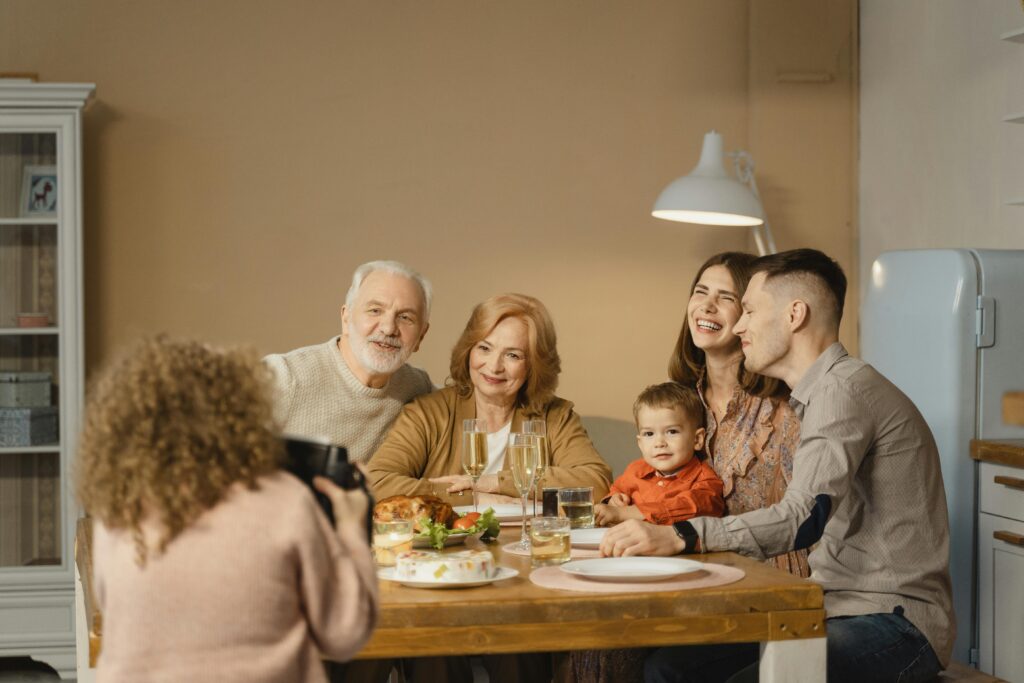 A joyful family celebrates together at a cozy indoor dinner.